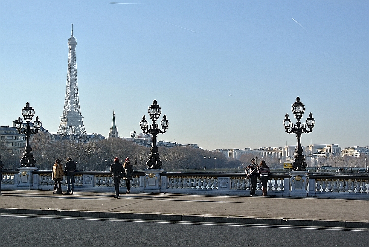Pont Alexandre III with young couples and tower